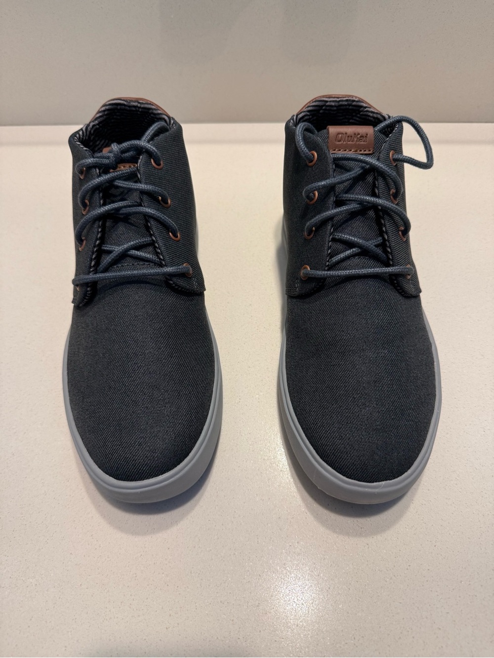 Brand New OluKai Men's Charcoal Gray Canvas Chukka Boots with Light Gray Sole.